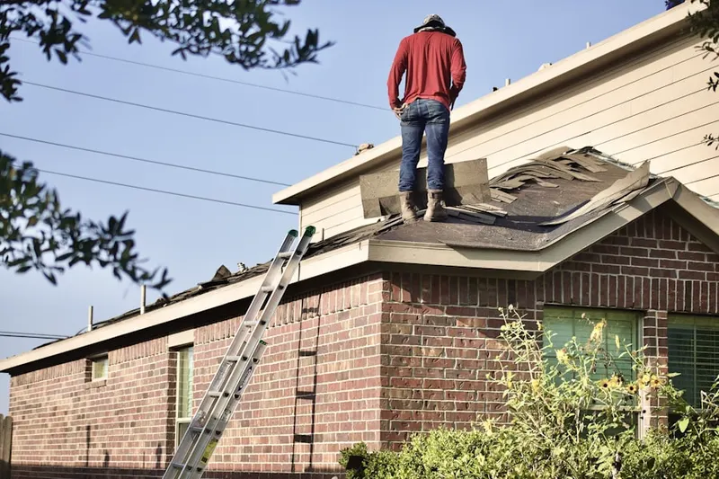 Professional roofer working on a residential roof in Bucksville Manor